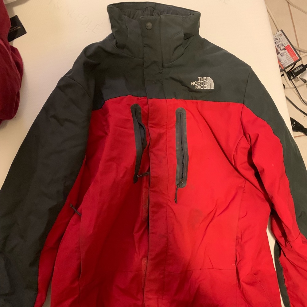 Red and grey north face jacket
